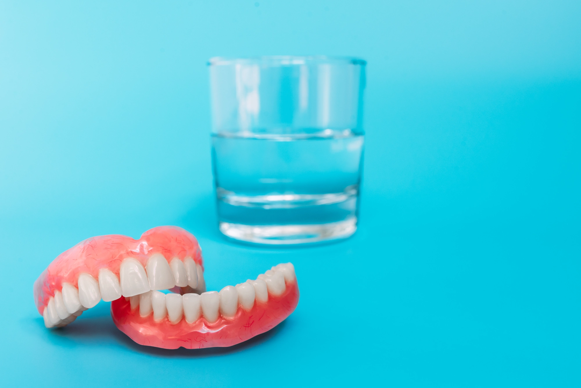 Image of Another angle of dentures in water glass | Plano Smile Studio